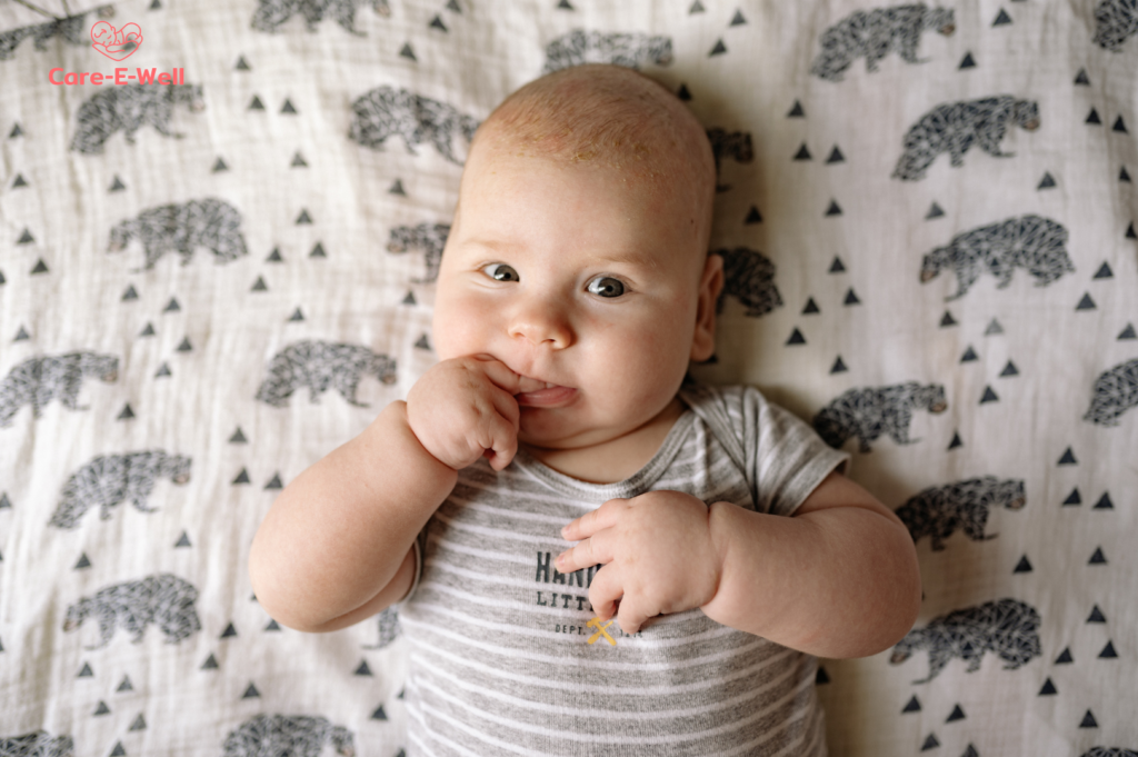 Newborn showing early feeding cues by bringing hands toward the mouth